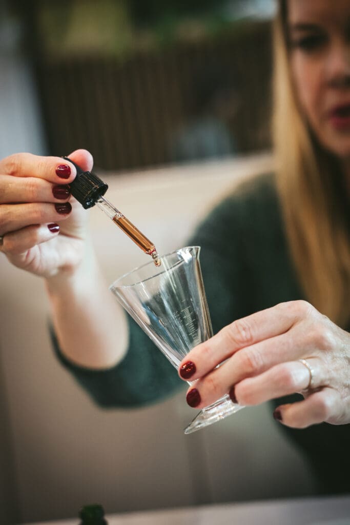 Melinda McDougall, using dropper to put liquid into the cylinder