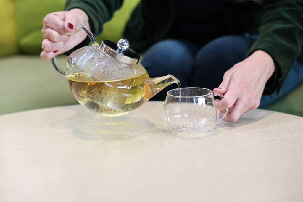 Melinda McDougall, herbal tea in a pot, pouring in the cup